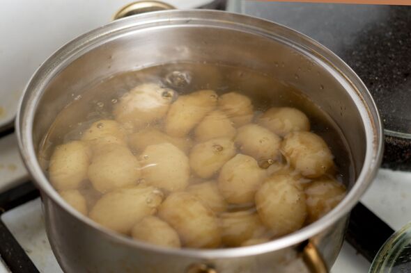 Potatoes boiling in a saucepan. Cooking young potatoes.