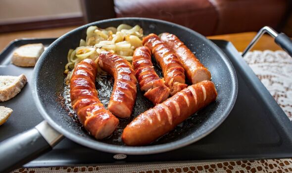 Sausages frying in a pan 
